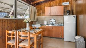a kitchen with a table and a refrigerator at Casa fig Crete in Chania