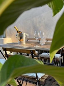 a table with a bottle of champagne and two wine glasses at Nella Corte - La Casetta in Corte Franca