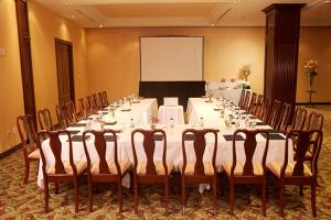 a long table with white tables and chairs in a room at The Green Park Boutique Hotel and Grand Suites - Chapultepec Parkfront in Mexico City