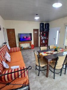 a living room with a couch and a table at Sudecada in Toay
