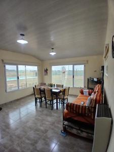 a living room with a table and chairs at Sudecada in Toay