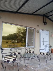 a group of chairs and a table on a patio at Sudecada in Toay