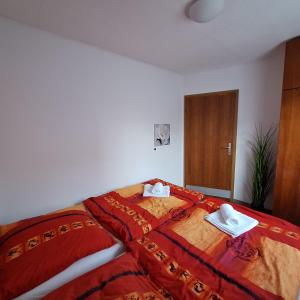 a bedroom with a bed with two hats on it at La Verena apartment Terme Čatež in Čatež ob Savi