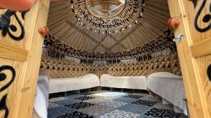 an inside view of a gazebo with a ceiling at Yurt Camp by Fly Service in Song-Kul +11 photos