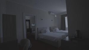 a hotel room with two beds and a mirror at New Welcome House Hotel in Alexandria
