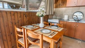 a kitchen with a wooden table with a vase of flowers on it at Casa fig Crete in Chania