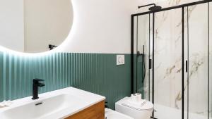 a bathroom with a toilet and a sink and a shower at Elegantis Luce di Trastevere Apartment with Terrace - Comfort in Most Charming District in Rome +17 photos