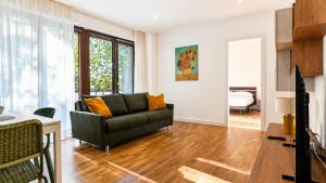 a living room with a couch and a table at Elegantis Luce di Trastevere Apartment with Terrace - Comfort in Most Charming District in Rome
