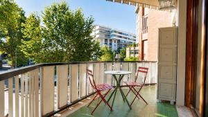a patio with two chairs and a table on a balcony at Elegantis Luce di Trastevere Apartment with Terrace - Comfort in Most Charming District in Rome