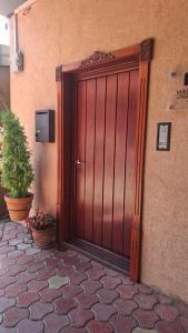 a wooden door of a building with a potted plant at Marilyn Apartments in Smederevo