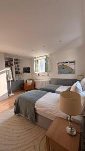 a bedroom with two beds and a table with a lamp at Chateau Mont Joly in Gan +19 photos