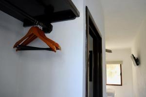 a red object is hanging on a wall at Paseo Kuka by ÓOL Hotels in Holbox Island