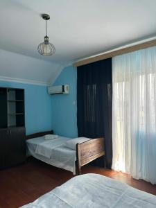 a bedroom with two beds and a window at Cactus Hotel in Kobuleti