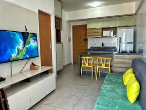 a living room and kitchen with a couch and a television at 2802 Unique · Studio Unique c/ garagem in Belém