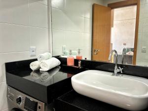 a bathroom with a sink and a mirror at 2802 Unique · Studio Unique c/ garagem in Belém