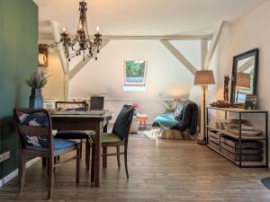 a dining room with a table and chairs at Ferienwohnung im Loftstil in Hemmoor +10 photos