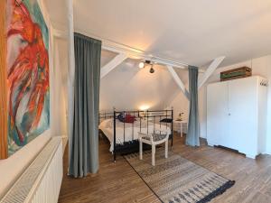 a bedroom with a bed and a large painting on the wall at Ferienwohnung im Loftstil in Hemmoor