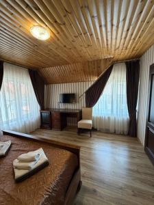 a bedroom with a bed and a chair and a television at Villa Lamperti in Dyyda +143 photos