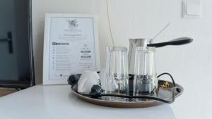 a tray with two glass blenders on a table at Atina Apartments in Peštani