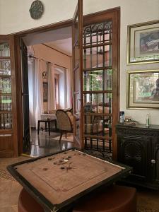 a room with a table and a mirror at Serendipity House Goa in Nerul