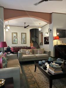 a living room with couches and a coffee table at Serendipity House Goa in Nerul