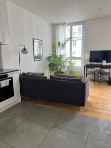 a living room with a black couch and a table at Luxury Apartment in Central Geneva in Geneva