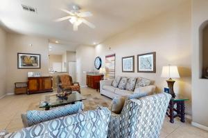 a living room with two couches and a ceiling fan at Lovely La Quinta - 66318 in La Quinta