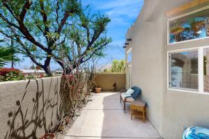a house with two chairs and a window on a sidewalk at Lovely La Quinta - 66318 in La Quinta