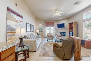 a living room filled with furniture and a ceiling fan at Lovely La Quinta - 66318 in La Quinta