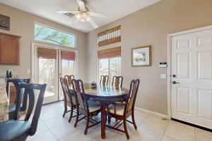 a dining room with a table and chairs and a ceiling fan at Lovely La Quinta - 66318 in La Quinta +17 photos