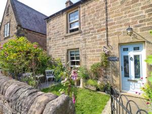 an old brick house with a blue door at Sunnyside in Matlock