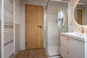 a bathroom with a shower and a sink and a mirror at Start Point Apartments in Žirovnica +73 photos