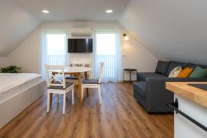 a living room with a table and a couch at Start Point Apartments in Žirovnica