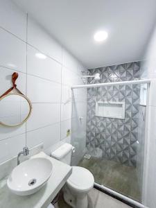 a white bathroom with a toilet and a sink at Di Villa Búzios in Búzios +35 photos
