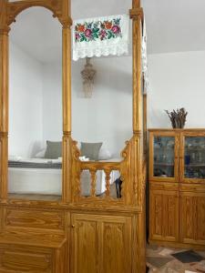 a bedroom with a wooden bed and a wooden cabinet at Antiperatos Beach house in Karpathos