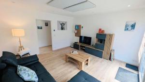 a living room with a couch and a coffee table at Ferienwohnung Wittle in Weiler-Simmerberg