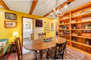 a dining room with a wooden table and chairs at Idyllwild Glory Days in Idyllwild +26 photos