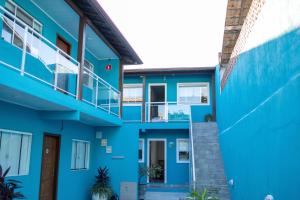 a blue building with a stairway and a balcony at Di Villa Búzios in Búzios