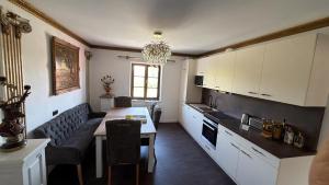a kitchen with a couch and a table in a room at Theresiengarten in Bad Wörishofen