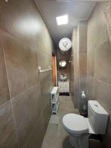 a small bathroom with a toilet and a sink at Pranvera in Pogradec
