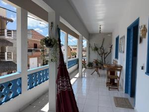 a dress hanging on a wall in a hallway at Pousada Flor de Sal in Prea