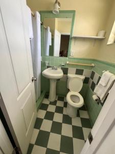 a bathroom with a toilet and a sink at Budget Inn Ocala in Ocala +46 photos