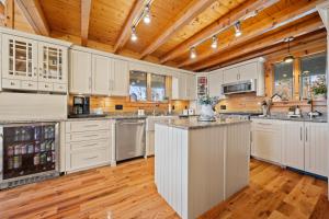 a kitchen with white cabinets and a wooden ceiling at Pleasant View in Island Falls