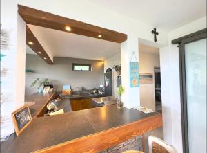 a kitchen with a counter top in a room at Blue Zebra - Seaview Sunset Apartment 1 in Tamarin