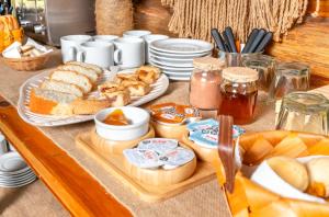 a table with a tray of bread and other food at Cabañas Bella Vista in Bella Vista
