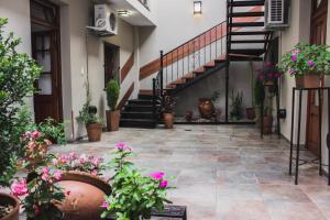 a courtyard with potted plants and a staircase at Inti Masi in Salta