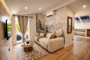 a living room with a couch and a table at La Verriere & Le refuge in Foix