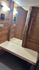 a room with wooden walls and shelves in a sauna at Hotel Kukučka Apartament Janka C105 Tatranská Lomnica in Vysoké Tatry