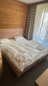 a large bed in a bedroom with a window at Hotel Kukučka Apartament Janka C105 Tatranská Lomnica in Vysoké Tatry +16 photos