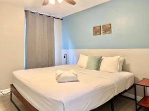 a bedroom with a large bed with white sheets at Downtown Condo! Private Balcony! PT10F in Atlanta